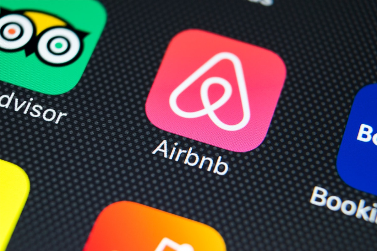 The Airbnb application icon on the screen of an iPhone.