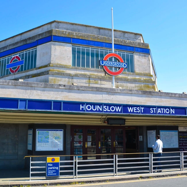 A man stands outside Hounslow West Underground station