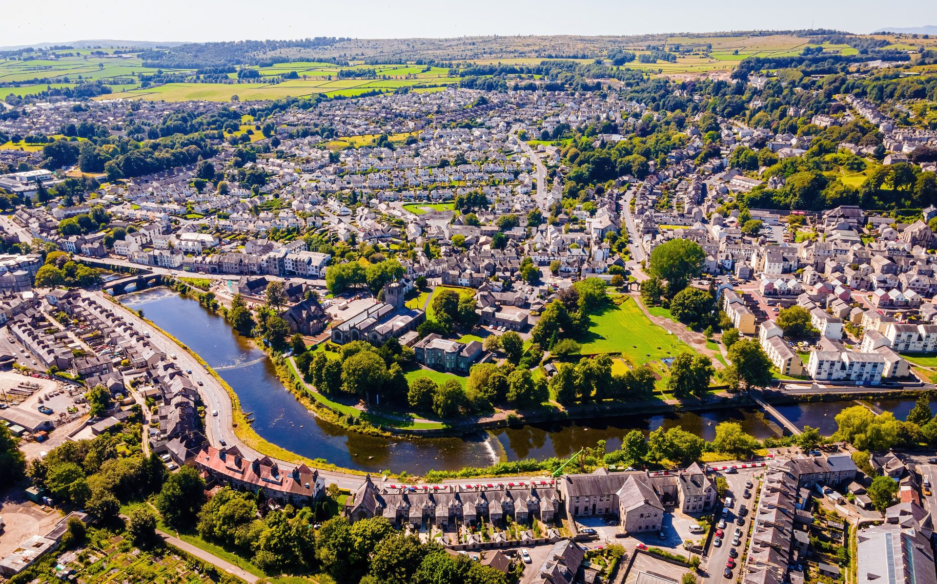 Aerial view of Kendal town centre and the River Kent, showing dense slate-roofed terraced housing