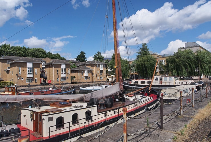 Canal boats moored in front of residential houses in Lewisham