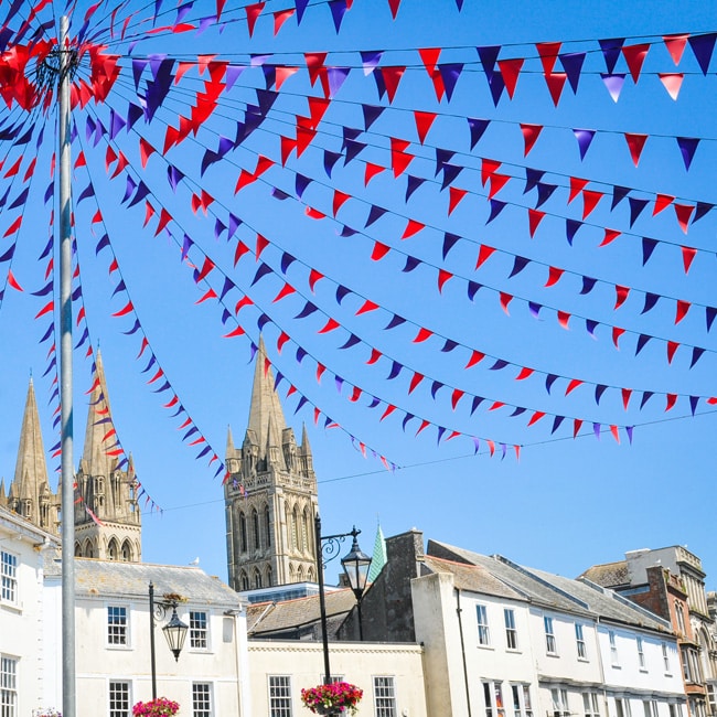 Bunting hangs from a flagpole in summer in the centre of Truro, Cornwall.