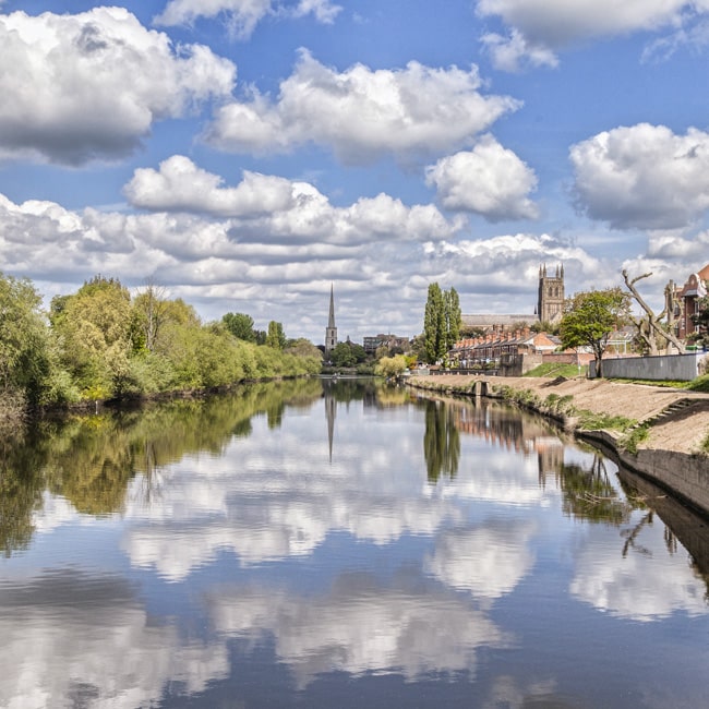 Clouds reflected in the River Severn with the city of Worcester behind