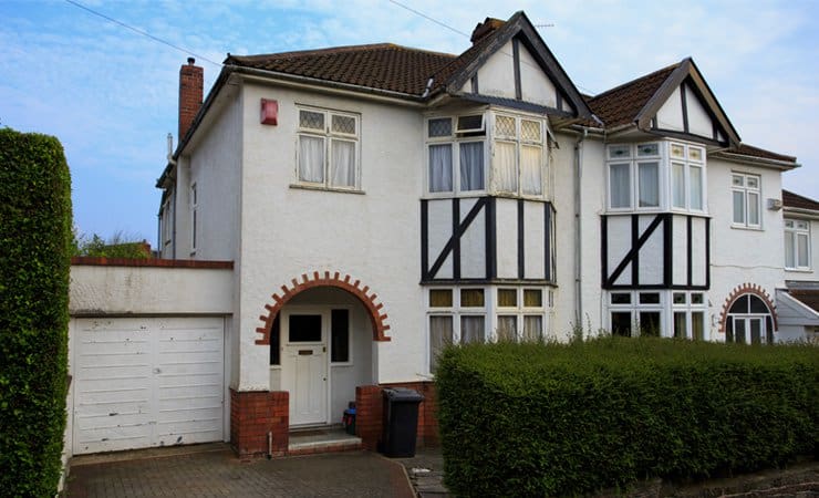 Photograph of a typical 1930s semi-detatched house with bay windows and a tall chimney. Photograph taken in Bristol, UK