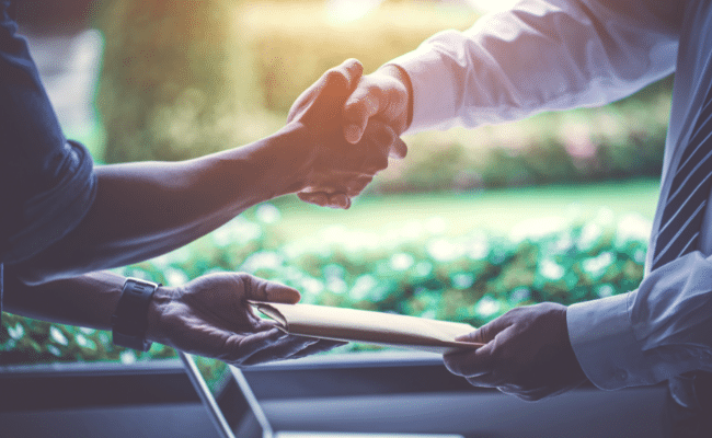 People shaking hands during a negotiation