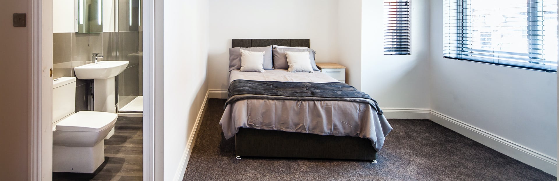 A bedroom with an en-suite bathroom in an HMO