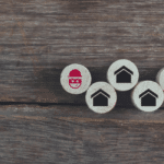 Small circle property scam icons on a wooden board