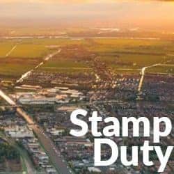 The words Stamp Duty are written over the top of an aerial image of a UK town.