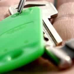 A close up photograph of a set of keys on the palm of someone's hand.