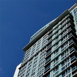 Looking up at a modern apartment block.