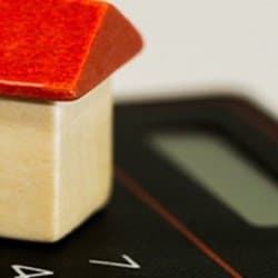 A close up photograph of a wooden model of a house.