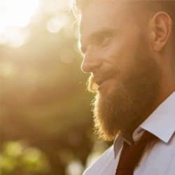 A man with a beard in a tie represents a possible business partner.