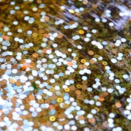 Coins lie at the bottom of a fountain.