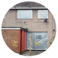 An empty terraced house with metal shutters, Salford. An empty home.