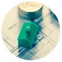 A circular image showing a Monopoly game house on an architectural plan next to a pile of coins.