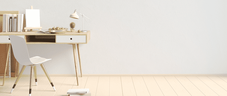 Photograph of a minimalist interior of a modern studio aparment as would be seen in purpose built student accommodation. Image shows a desk on a hardwood floor