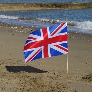 A photograph of a Union Flag, sticking out of the the sand on Shanklin Beach on the Isle of Wight.