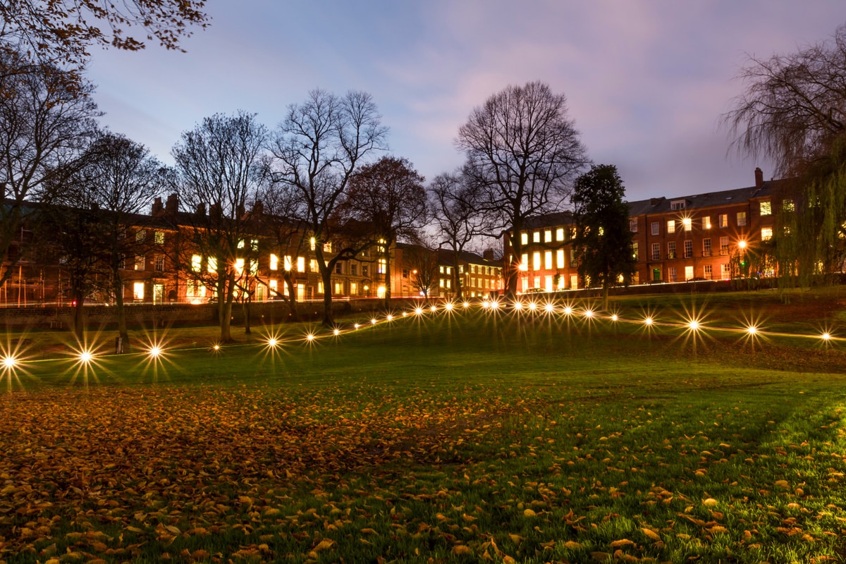 Lights in a block of floats are on as the sun goes down over Winckley Square in Preston, Lancashire.