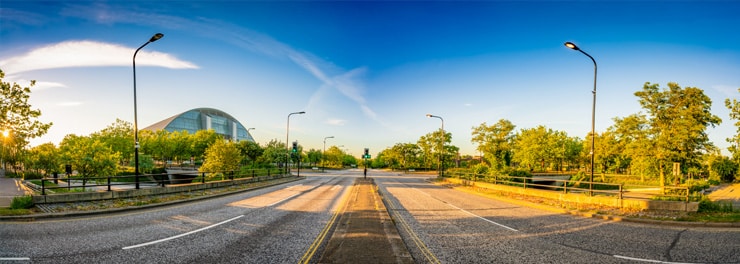 A photograph of Avebury Boulevard in Milton Keynes, deserted at sunset on a summer day.