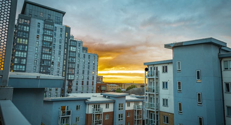 A view of a sunset behind some modern residential apartments in Slough town centre