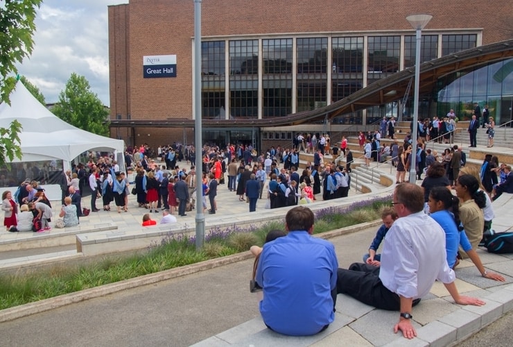 An outdoor graduation ceremony at the University of Exeter.