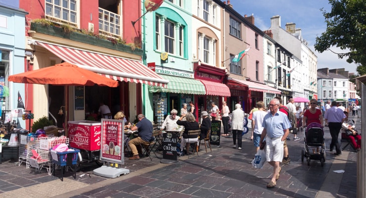 Tourists enjoying the sun, shopping and eating on Palace Street, Caernarfon