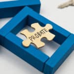 A jigsaw piece with the word 'probate' written on it, rests on blue, wooden blocks in the shape of a house.