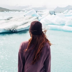 A woman looks towards a shelf of ice.