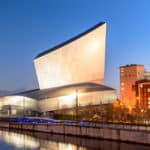 A photograph of the iconic Imperial War Museum at Salford Quays. Photograph taken at dusk with a clear sky.