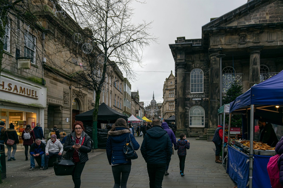 Lancaster City Museum in the busy Market Square, Lancaster. People enjoy the fresh food market, shopping in the high street retailers and relaxing on a busy Saturday