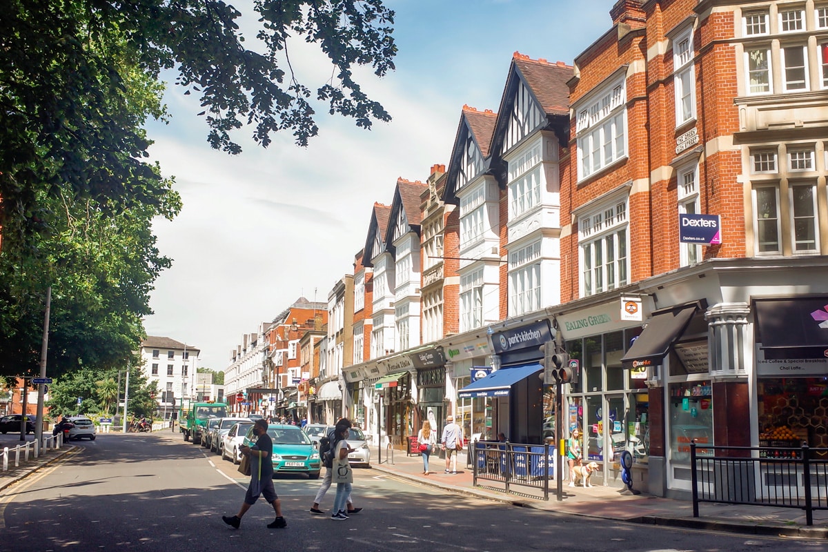 Ealing high street shops on a sunny day, an attractive residential area of West London.