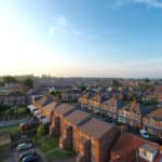 An aerial shot of rooftops on a suburban estate.