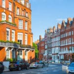 The residential area of Kensington and Chelsea. A photograph of a a row of periodic buildings in Cadogan gate. Image shows luxury property in the centre of London.