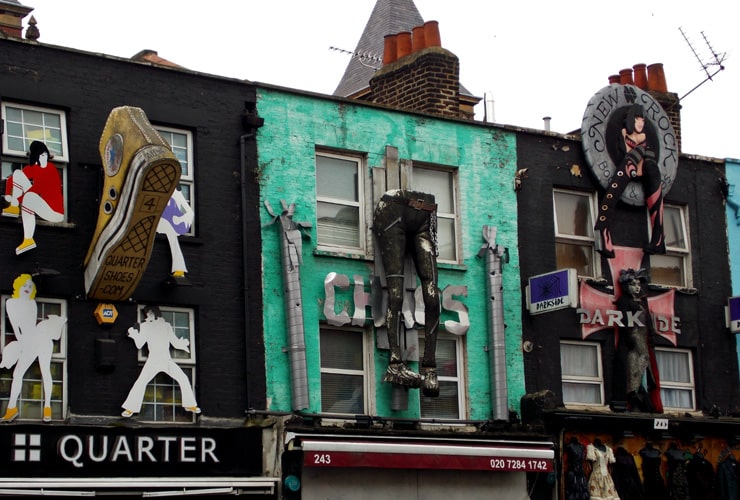 Artistic shop fronts in Camden Town. One shop has a giant boot hanging from it, the other a pair of trousers.