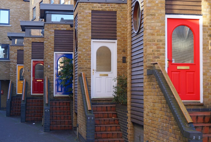 Different coloured doors of first-floor flats in Greenwich Village, London