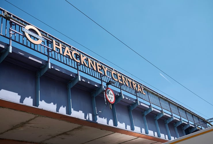 A railway bridge with the words, Hackney Central citing next to the Transport for London logo. This is the Hackney central overground sign.