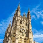 Canterbury Cathedral against a clear blue sky.