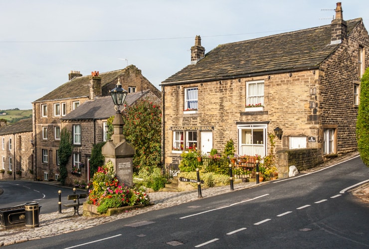 Old stone houses in the square in Dobcross, Oldham. One house was formerly the Saddleworth Bank.