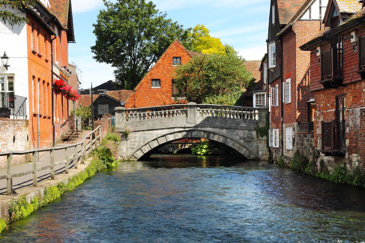 A bridge goes over the River Itchen in the heart of the city of Winchester.