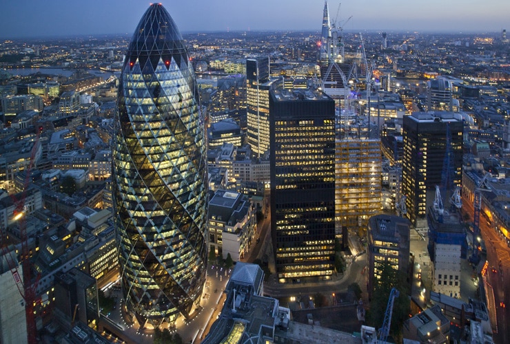 Aerial view of the City of London skyline at sunset.