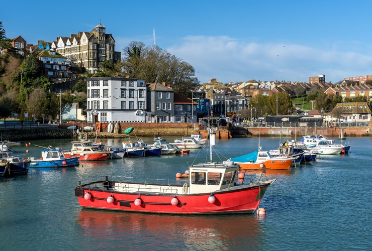 Boats floating on the harbour at Folkestone, Kent.