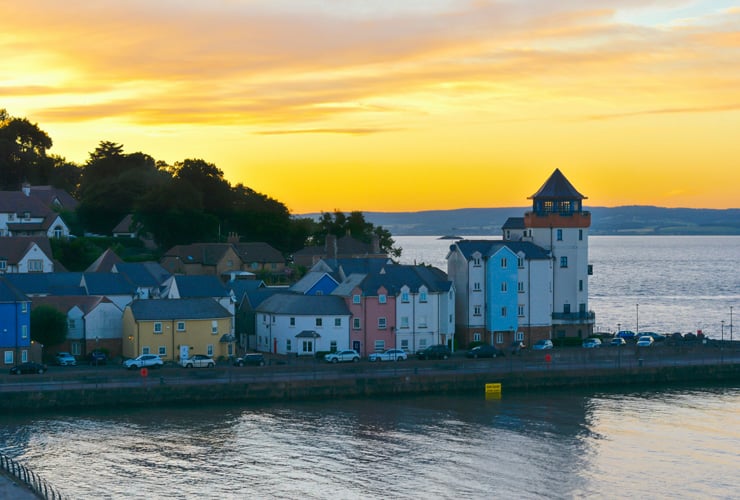 Sunset over the Fisherman's Village in Portishead. Colourful residential buildings along a waterfront.