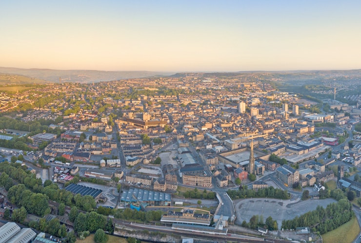 Aerial view of a sunlit Halifax in the early morning, Calderdale, West Yorkshire, UK.