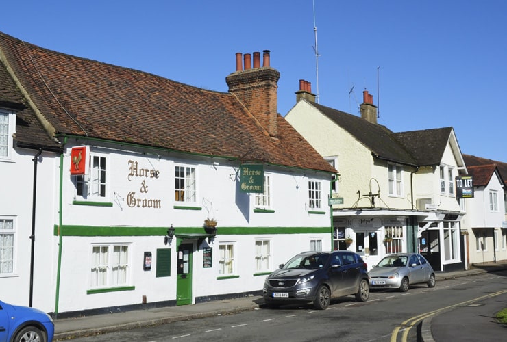 An old, white-painted pub on Park Street in Old Hatfield on a bright summer day.