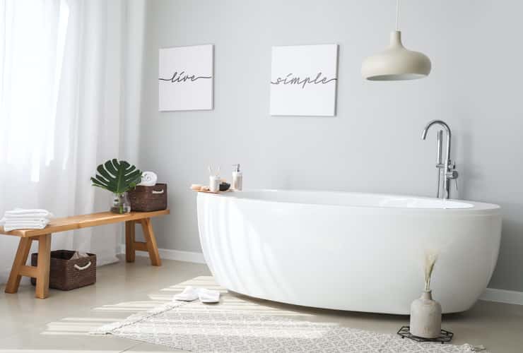 A slippler bath in a stylish, modern bathroom.