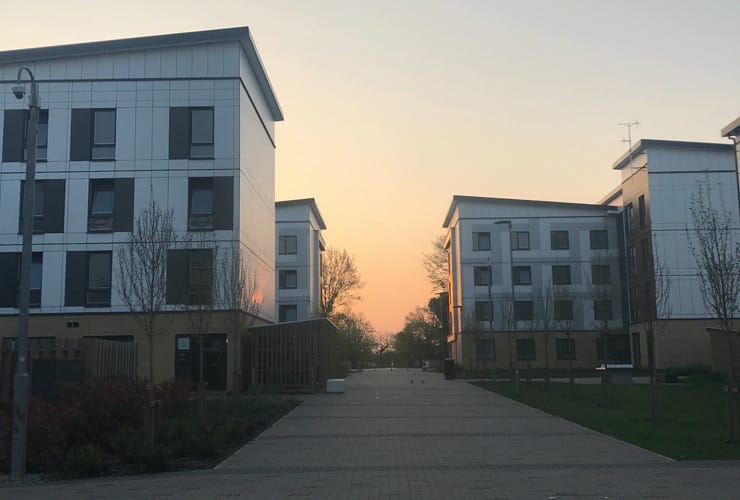 The sun rises over blocks of flats. Student accommodation in Hatfield.