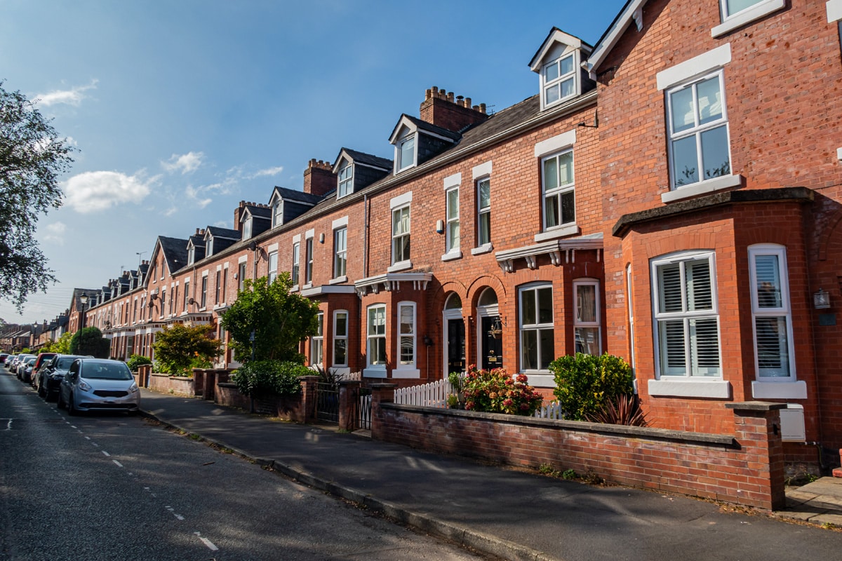 A typical residential street in Manchester with red-brick Georgian houses.