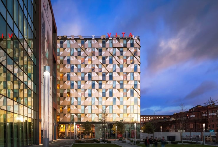 The outside of the Vita Student project at dusk. Photograph taken on First Street, Manchester.