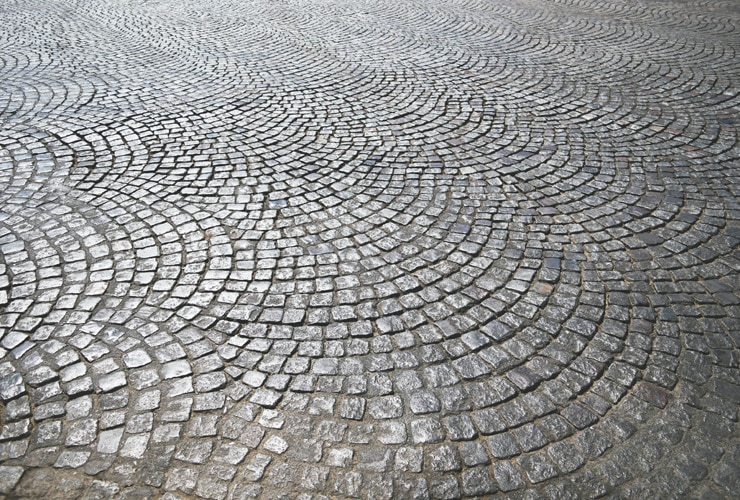 A close up of a patterned cobbled driveway.