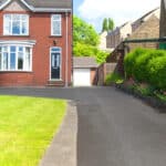 Typical English single family house built from red bricks, with a large driveway.