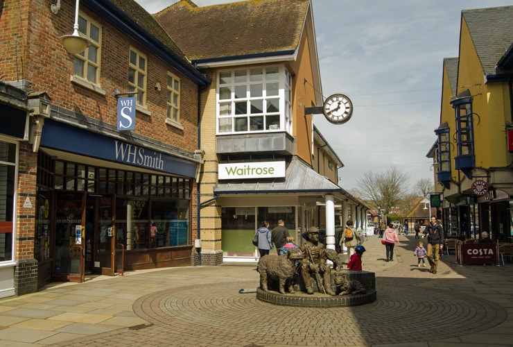 Shoppers walking on a pedestrianised road in town centre of Petersfield.